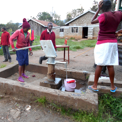 Students drawing water from Newly Repaired Pump