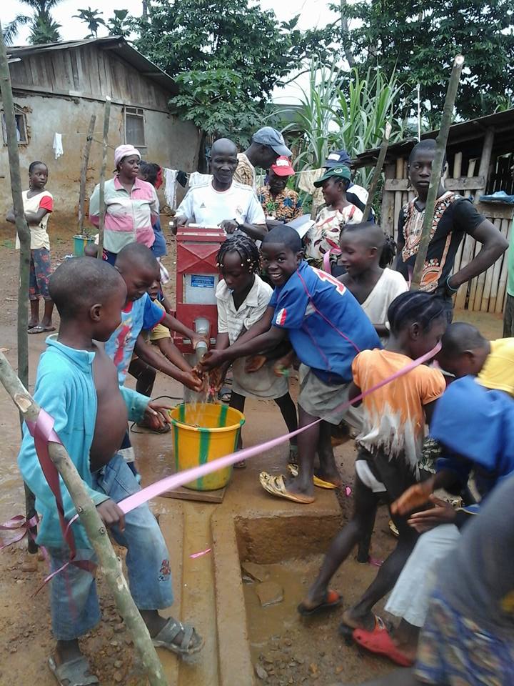 Excited children getting water from new well!