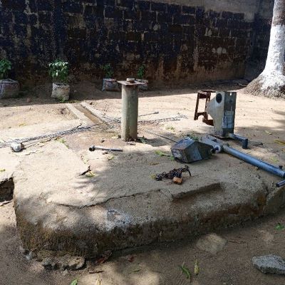 Village school hand pump undergoing repairs 