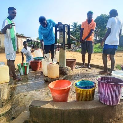 Villagers happy to collect water from the well after hand pump repair