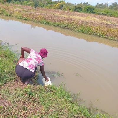 Village woman drawing water from a river, village's once source of water