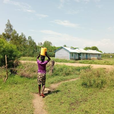 Village woman carrying home clean water