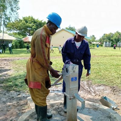 Hand pump repair team at work