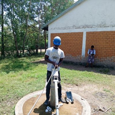 Village school hand pump undergoing repairs 