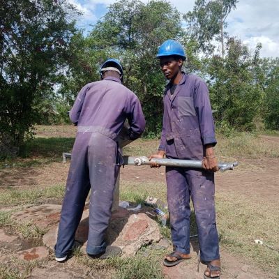 Community's hand pump undergoing repairs 