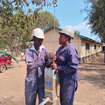 Hand pump repair team at work