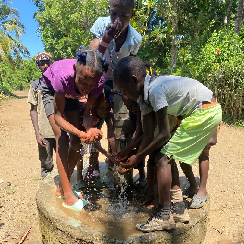 Children by newly repaired pump