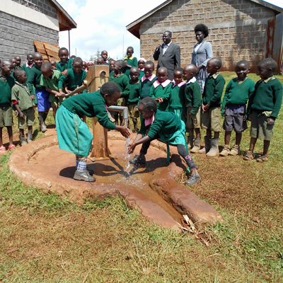 Children enjoying Newly Repaired Pump