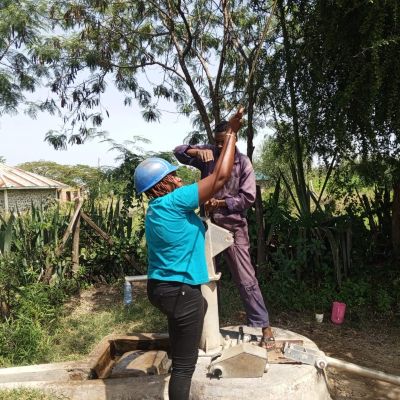 Hand pump repair team at work