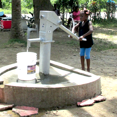 Young girl filling a bucket