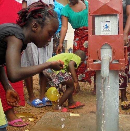 Young girl taking a drink of wonderful fresh water!