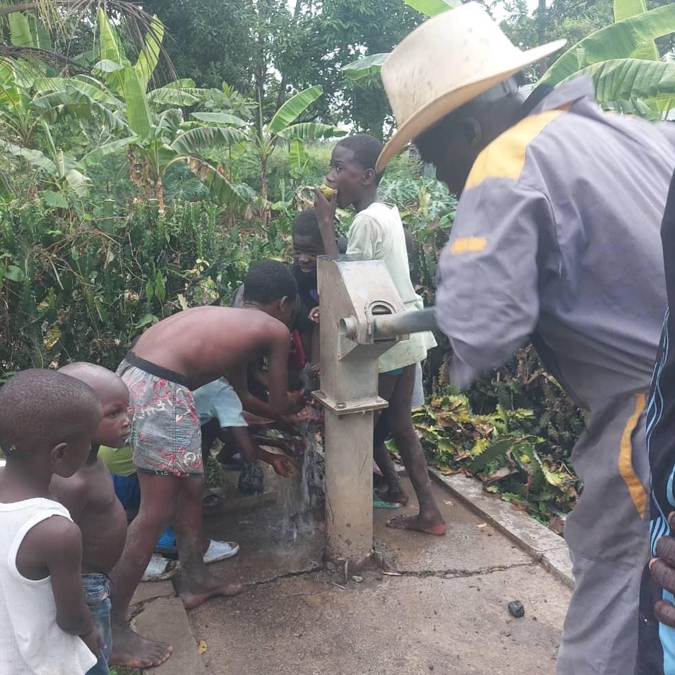 Children by newly repaired pump