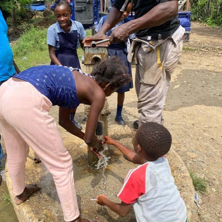 Children by  newly repaired pump