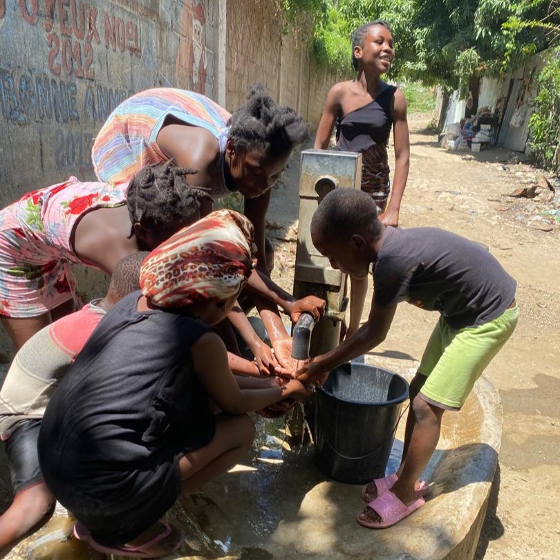 Villagers by newly repaired pump