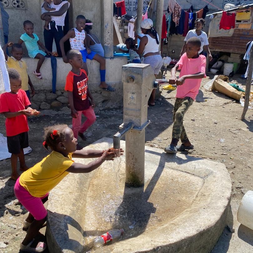 Child at newly repaired pump