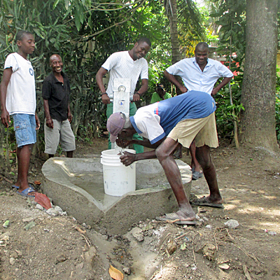 Village leader drinking frm New Well