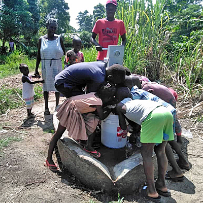 Excited children around the new well!