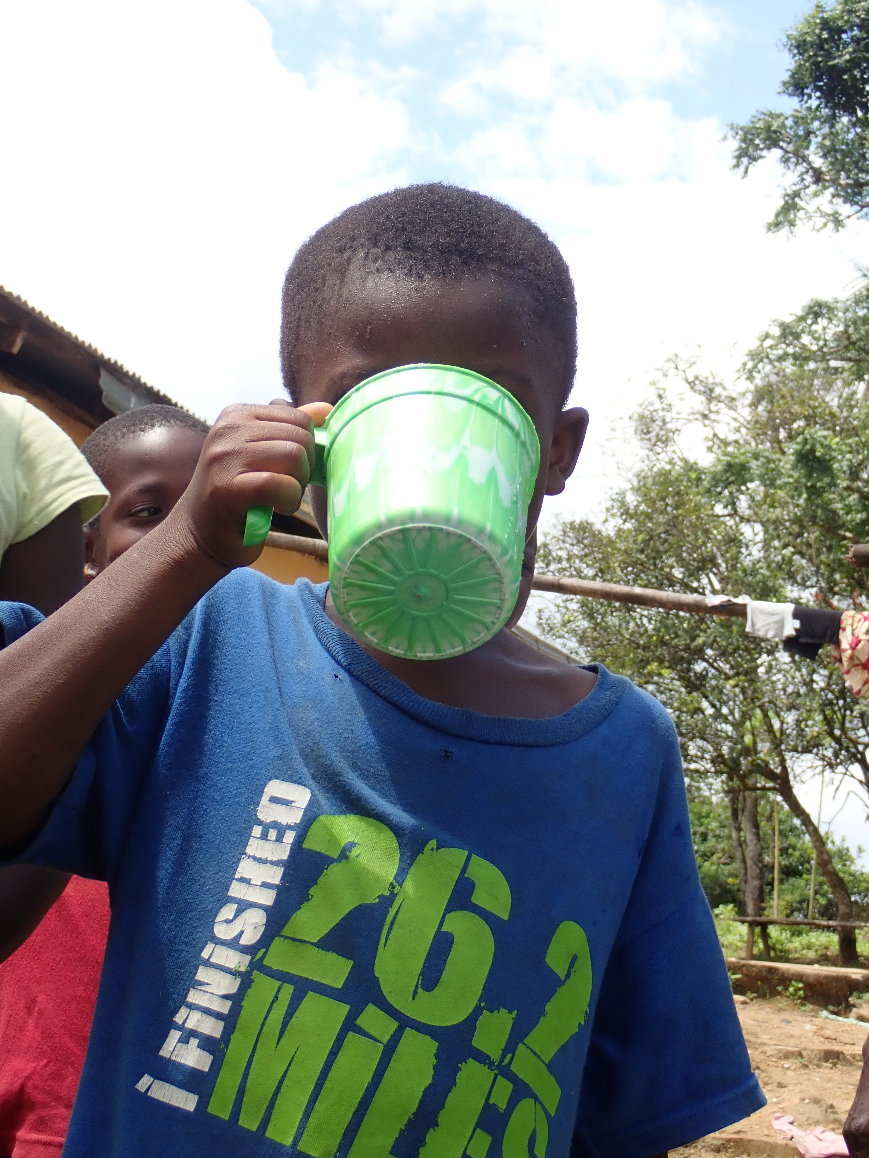Enjoying a drink of water after walking home from school