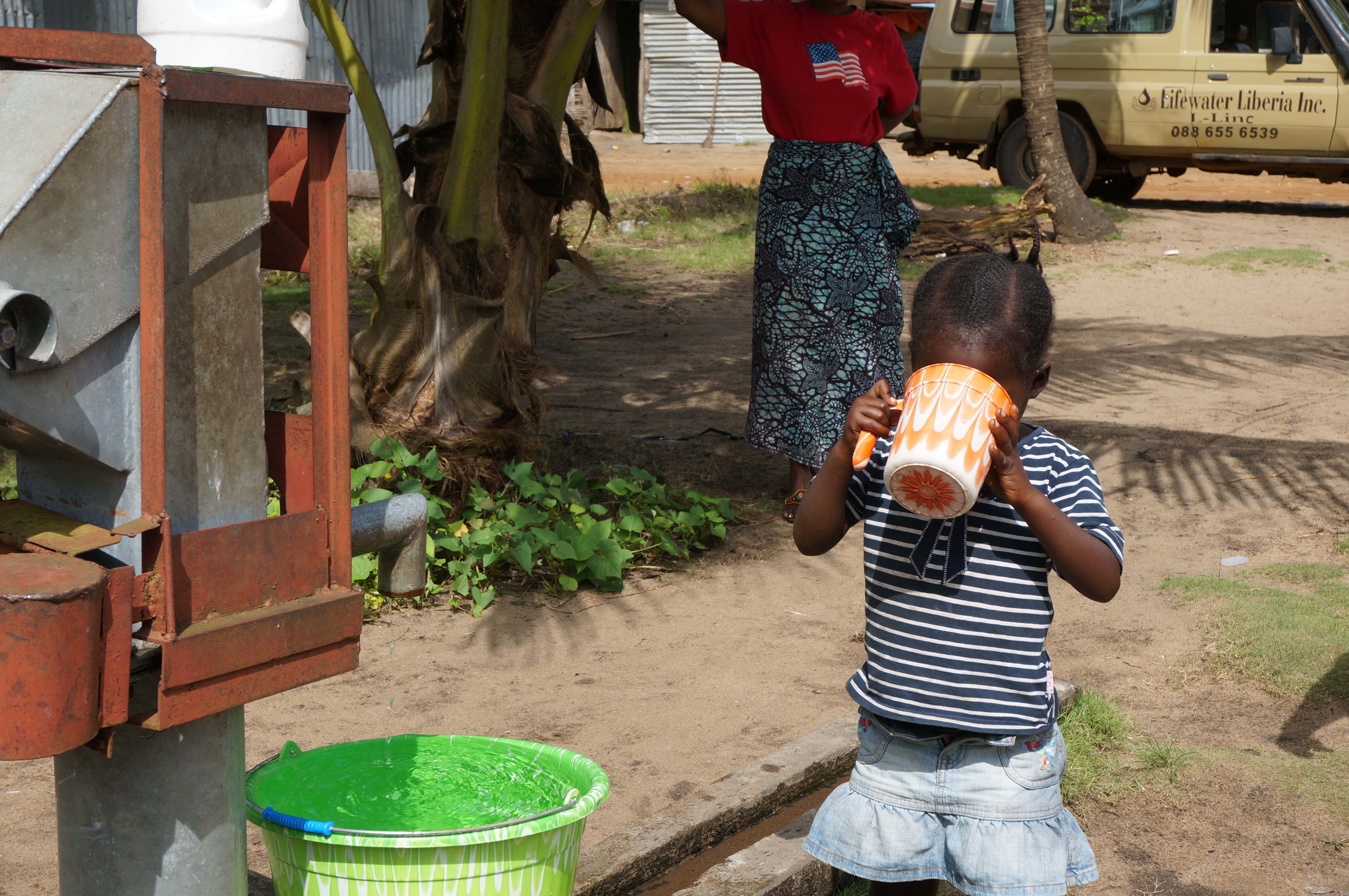 Child enjoying a long drink of water