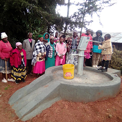People around their Restored well.