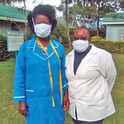 Clinic director and staff member wearing hand made masks
