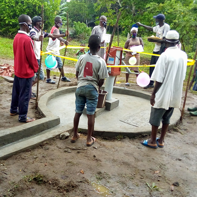 New Village Well, practicing Social distancing at celebration