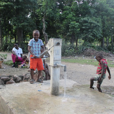 Children drawing from the newly repaired pump