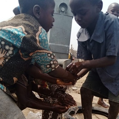 Children drawing water from newly rehabilitated well
