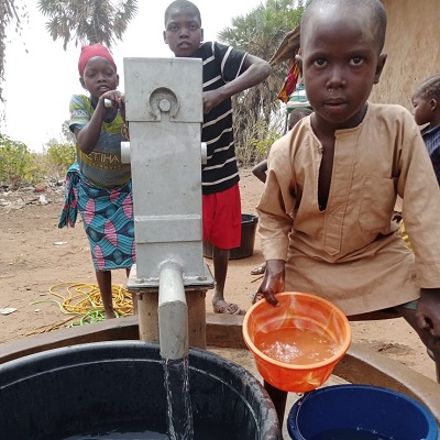 Children drawing water from repaired pump