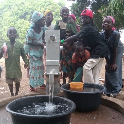 Happy children draw water