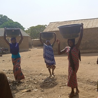Community Women bring sand for concrete