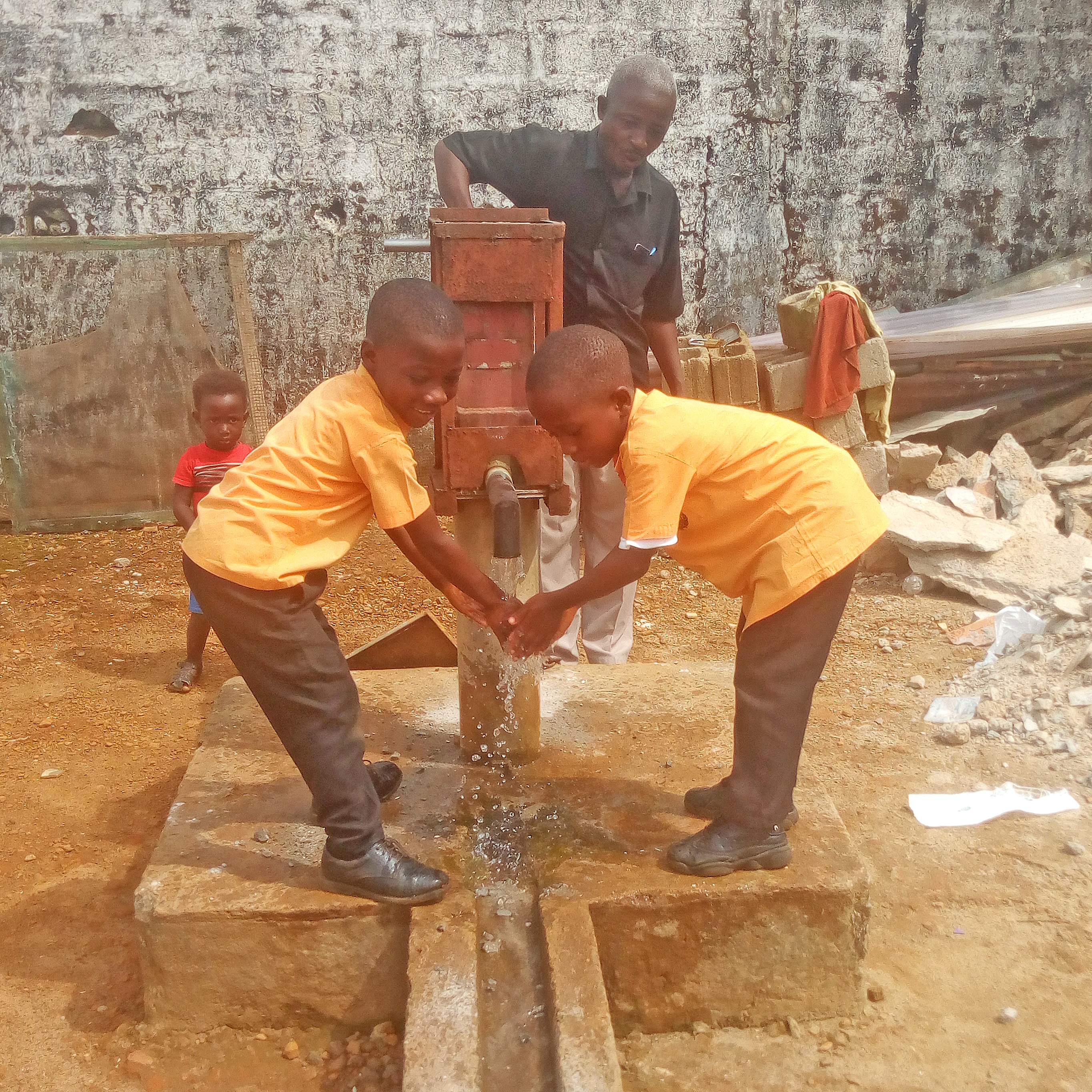 Children washing hands in clean water