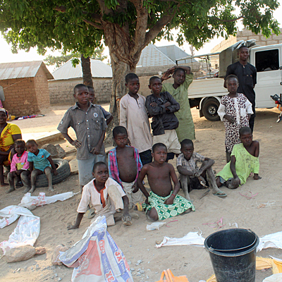 Villagers watching team pour Pump Pad