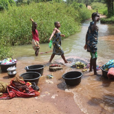 Children washing at community river 