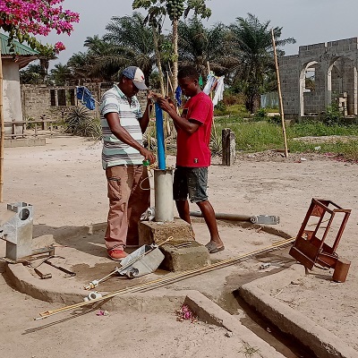 The team working on a broken handpump