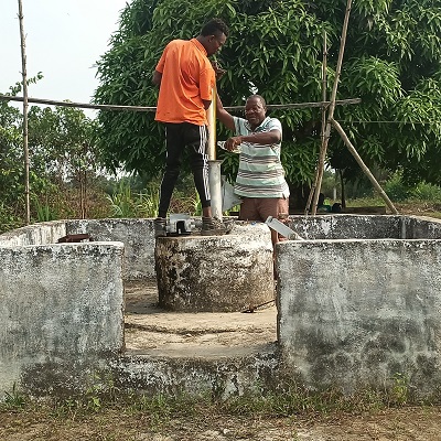 The team working to repair the broken hand-pump