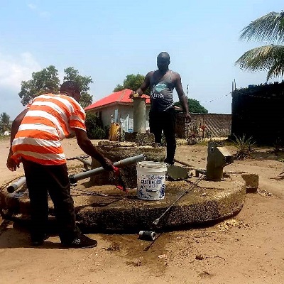 Team working to fix the broken hand-pump