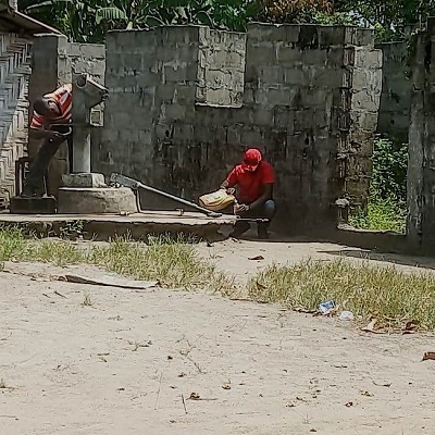 The team working to repair the broken hand-pump