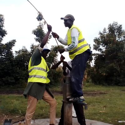 Hand pump repair team at work
