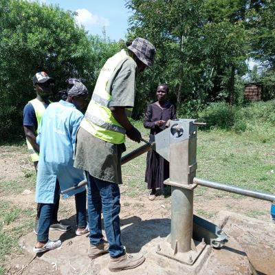 Hand pump repair team at work