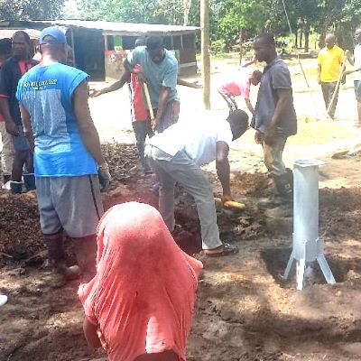 Hand pump installation team at work