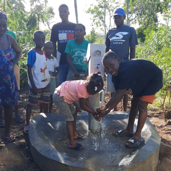 Children by newly repaired pump