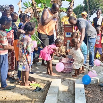 Community members celebrating the existence of a new well.