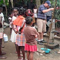 Children watching Team work on Pump
