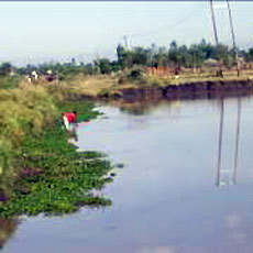 Child Drawing Water from Old Source