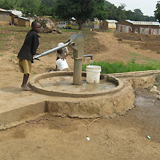 Boy drawing water from New Pump