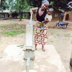 Mother and child pumping water