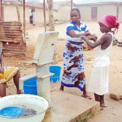 Girls pumping clean water