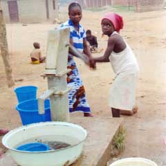 Girls pumping clean water